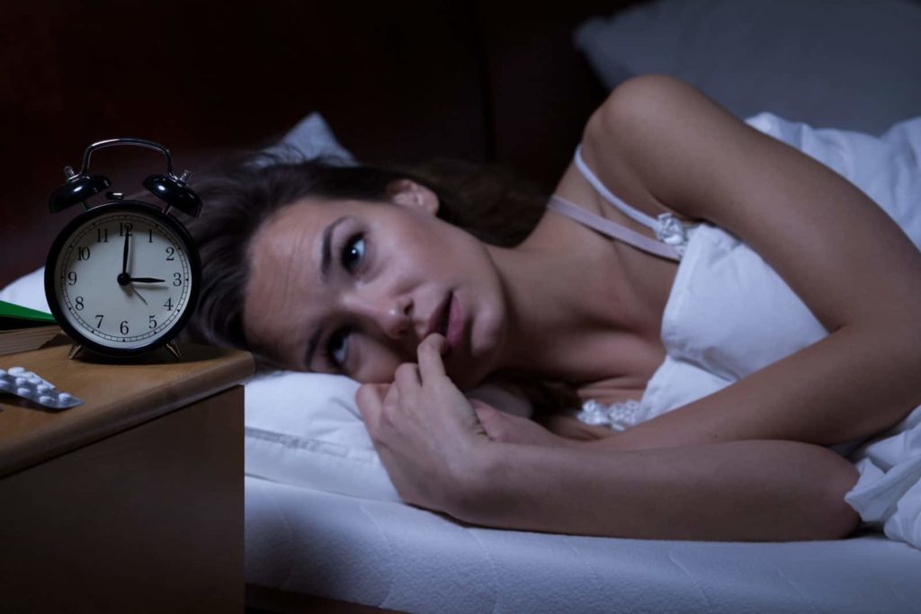 woman treats insomnia with pills
