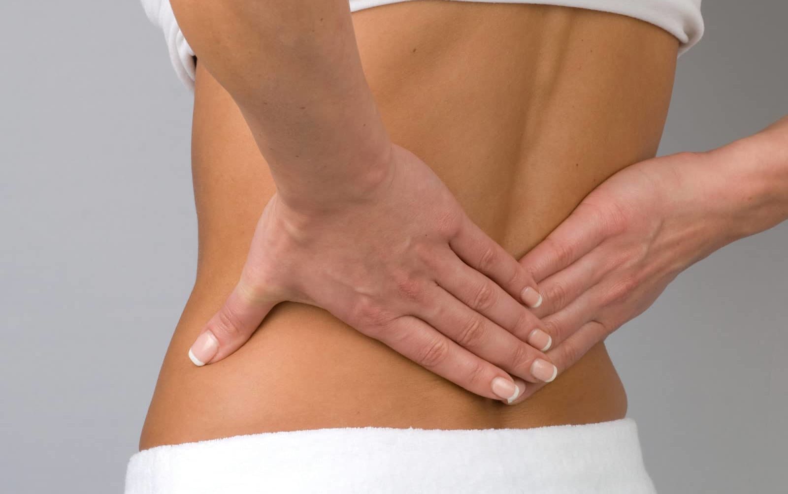 a person experiencing pain on the lower back