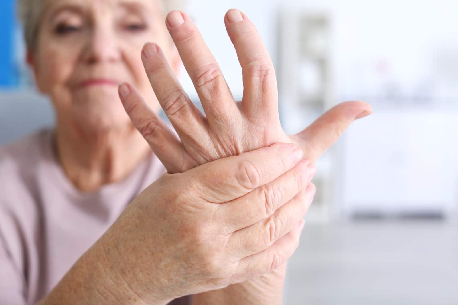 elderly lady showing her arthritic hands