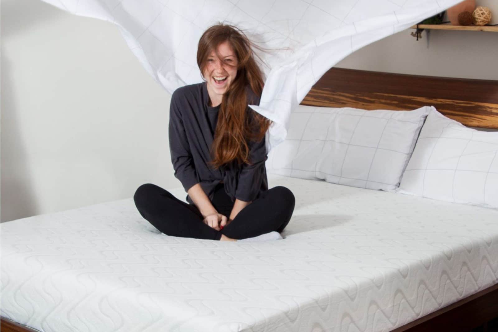 woman sitting on her nest beddings love and sleep bed