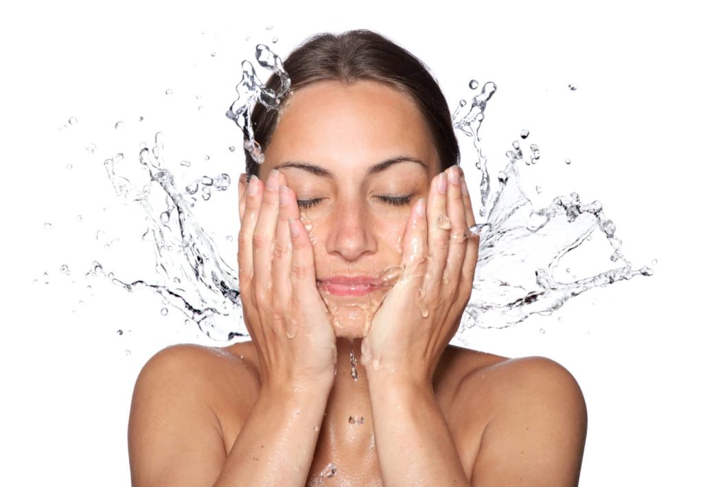 a lady washing her face