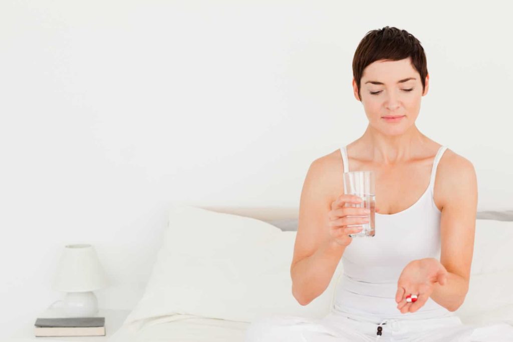 a woman about to take some pills