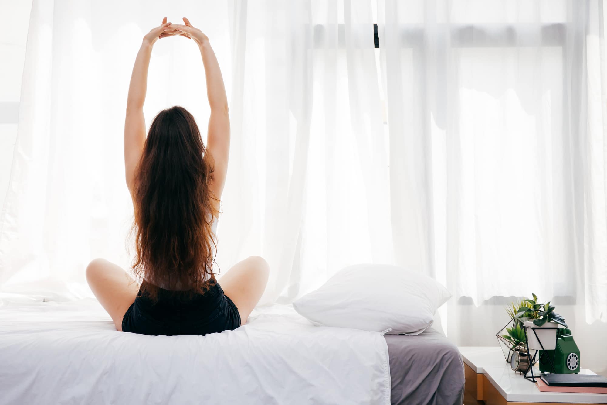 woman sitting up on bed