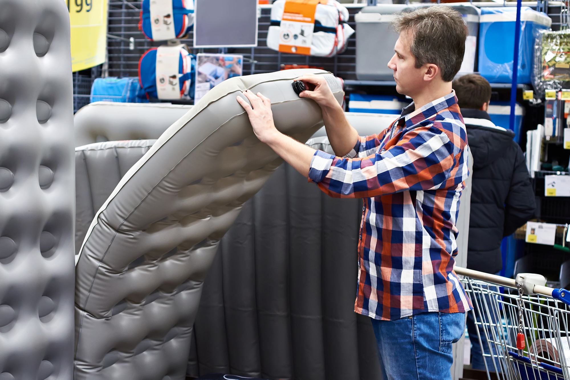 a man shopping for a blow-up bed