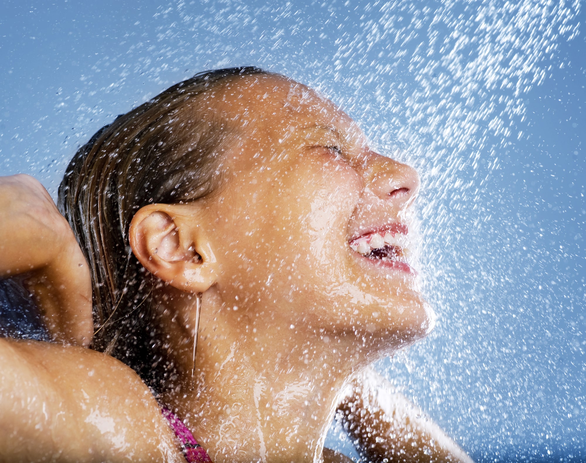 a woman enjoying a spray of water