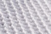 A close up of the best innerspring mattress covered in white sheets.