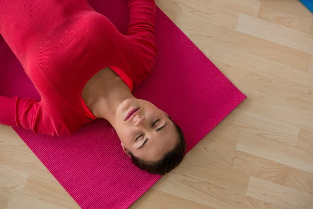 a woman lying on a mat